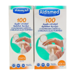 Compresses de soins Aldismed, format 5x5 cm, présentées individuellement. Elles sont blanches et présentent une texture douce, conçues pour l'hygiène et les soins de plaies, du visage et post-opératoires.